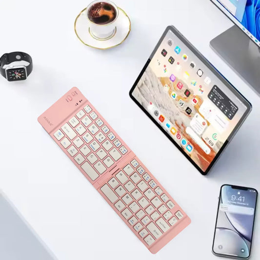Teclado AS1006 rosado conectado a una tablet y un celular sobre escritorio blanco