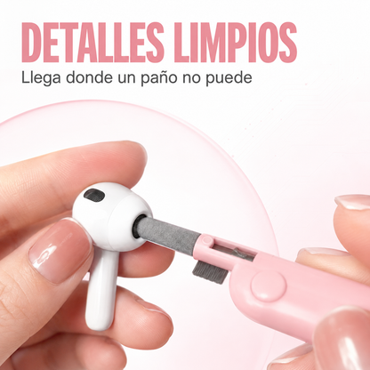Herramienta rosada del kit limpiando la malla de un audífono inalámbrico
